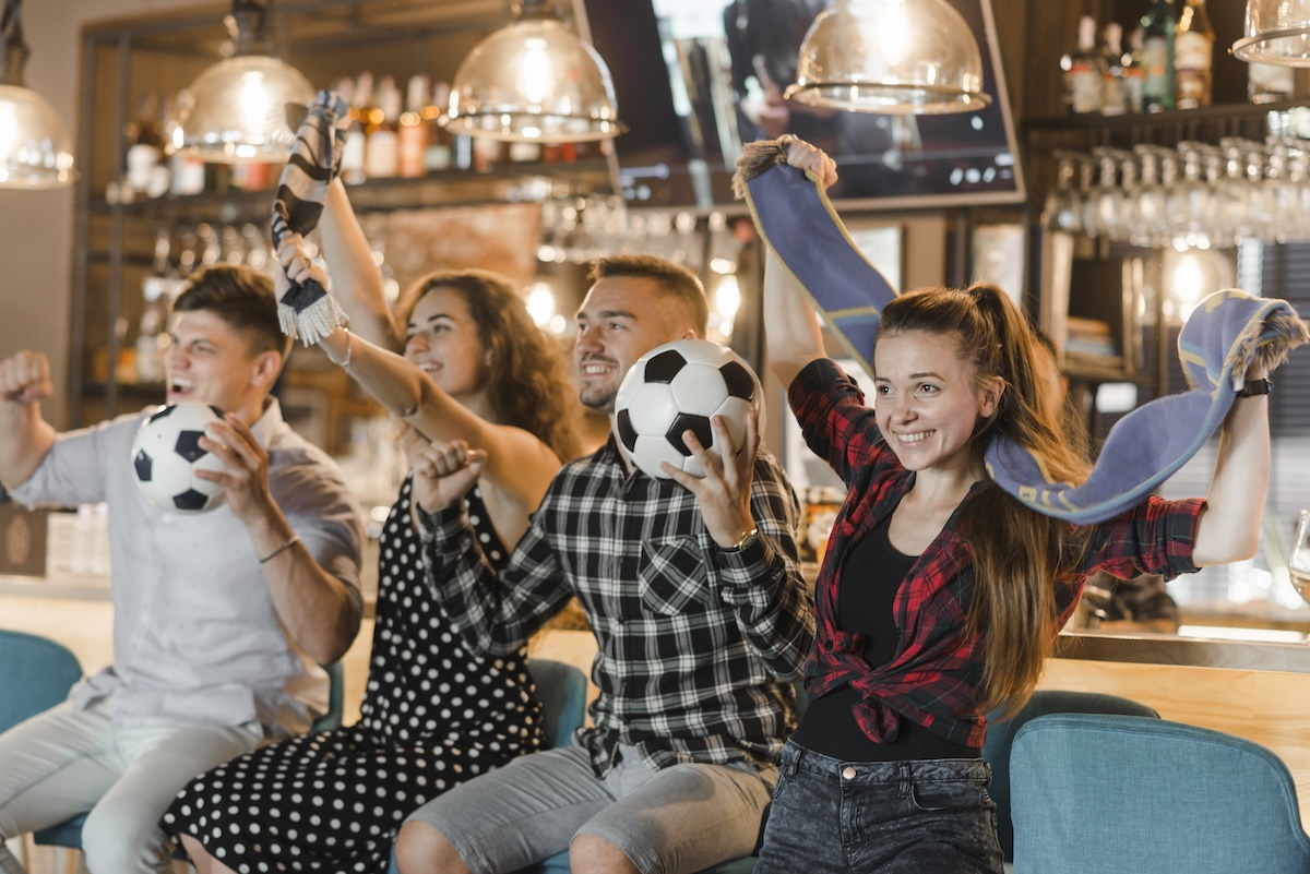 soccer-fans-sitting-bar-celebrating-victory