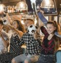 soccer-fans-sitting-bar-celebrating-victory
